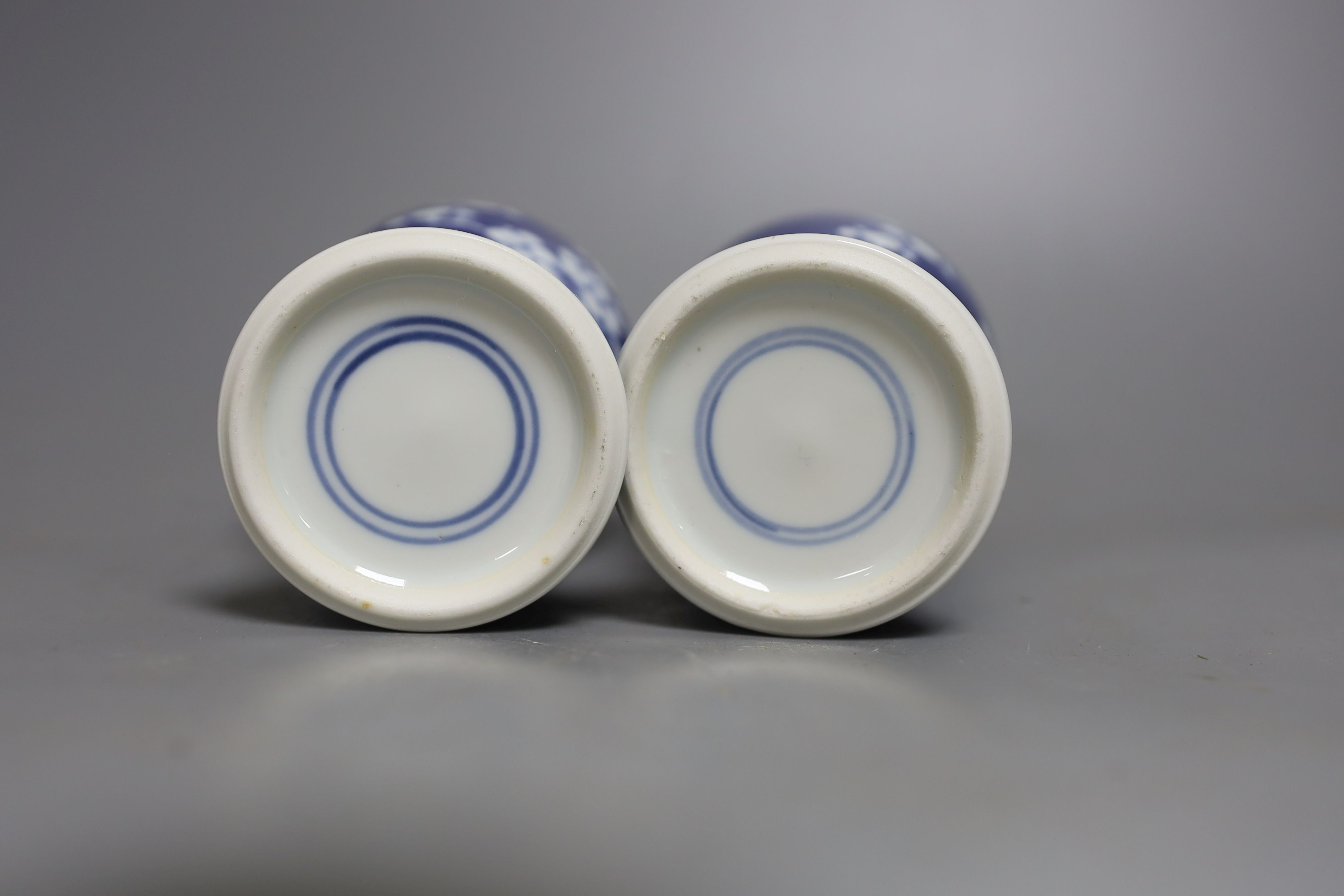 A pair of early 20th century Chinese prunus blue and white baluster form vases, 16 cms high.